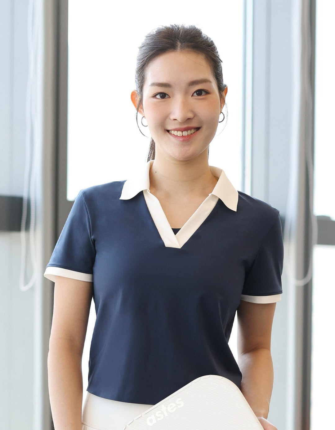 A beautiful girl is wearing a FLOAT Polo Slim Fit Contrast Crop Short Sleeve Short Sleeve from Her own words SPORTS 